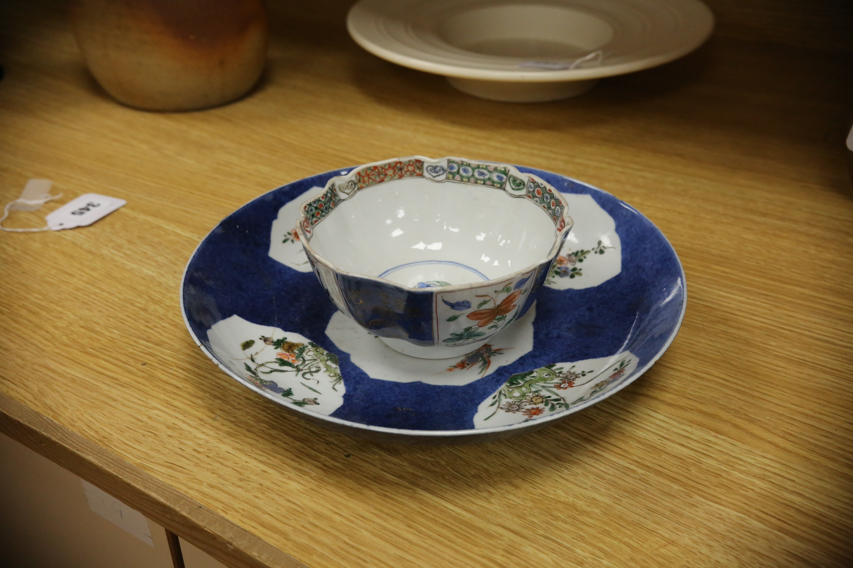 A Chinese famille verte powder blue ground bowl and a similar dish, both Kangxi period, 27.5cm diameter. Condition - dish poor, bowl fair